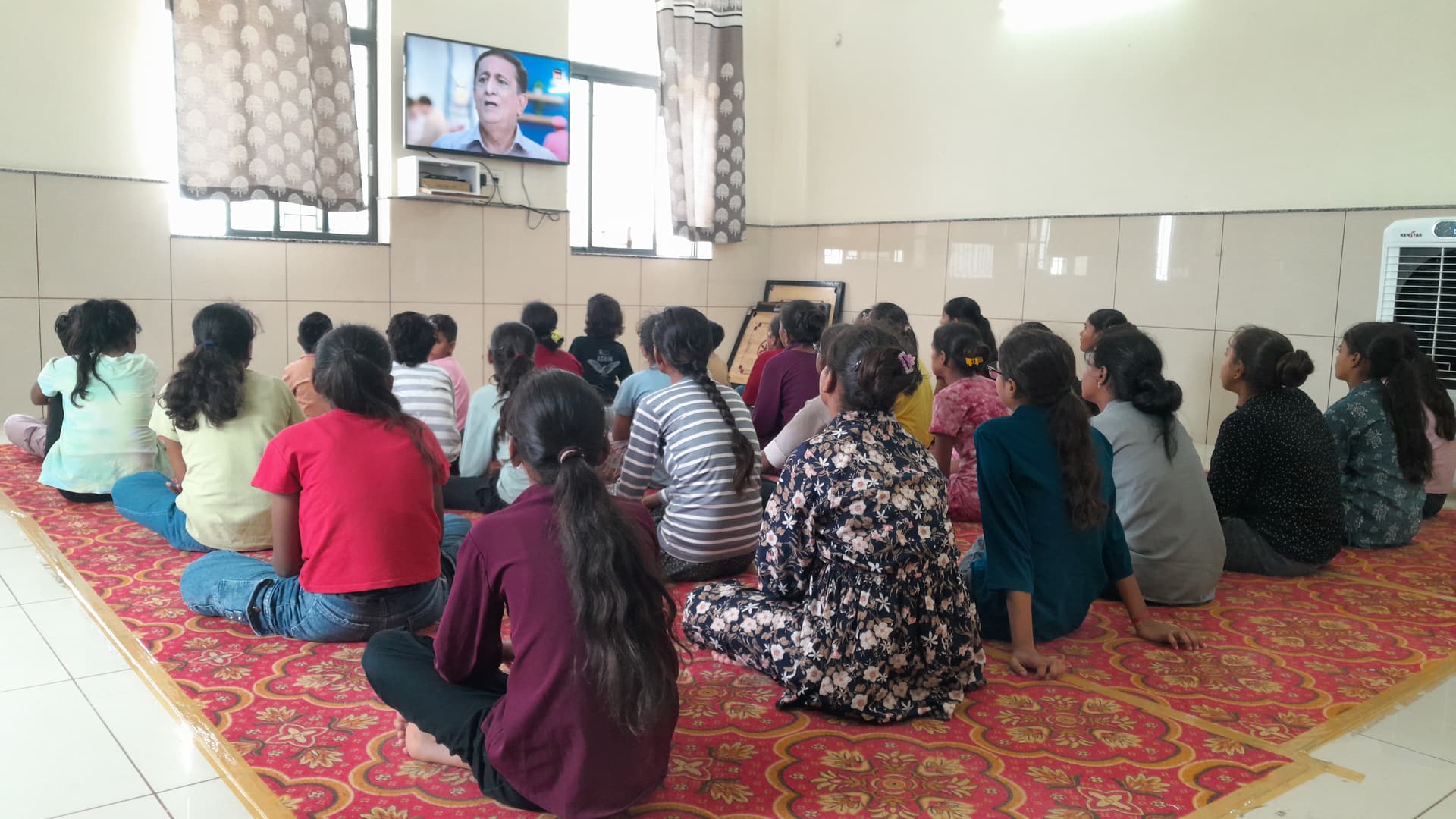 Children at Bal Basera watching television